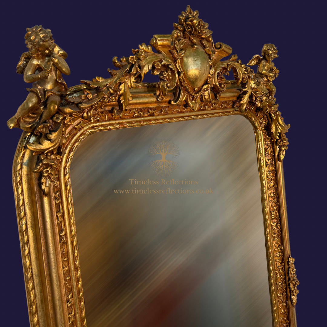 The Cherub Adorned Gilt Mirror